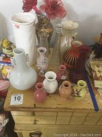 Full set of 13 vases on wooden table with various styles and colors visible.