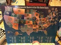Map display showing state outlines with slots holding commemorative quarters for each U.S. state.