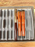 Three fountain pens in tray, caps on