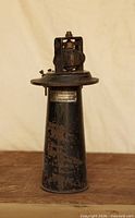 Full view of tall cylindrical Sparton horn on wood surface