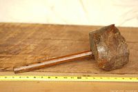 Side view of burl wood mallet showing head texture and ruler for scale
