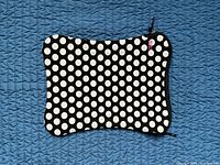 Front view of black sleeve with white polka dots and zipper