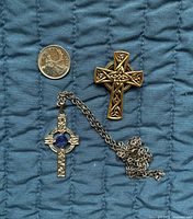 Front view of pendant, brooch, and scale coin