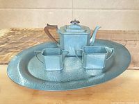 Full view of four-piece pewter tea service on tray