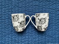 Front view of both floral mugs side by side