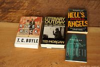 Four books laid out front covers visible