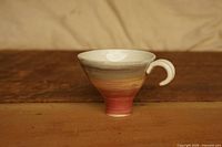 Front view of conical pour-over dripper showing glaze pattern and handle