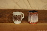 Front view of Fire King milk glass mug and Luisa pottery tea bowl side by side