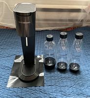 Front view of SodaStream Genesis with three bottles and pad