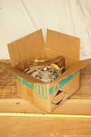 overview of cardboard box with mixed hardware