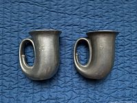 Both pewter horn-style mugs side by side showing shape and handles