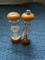 Front view of both dispensers showing wood tops and acrylic bodies