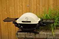 Grill displayed with both side tables extended showing overall form
