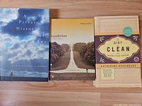 Front view of all three books standing side by side showing covers