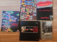 Five oversized books laid out showing covers