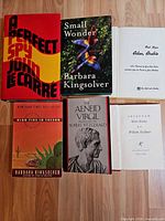 All four books laid out front covers and two title pages visible