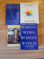 All four paperback books laid out showing front covers