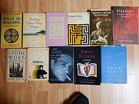 Group shot of 11 assorted books laid out on floor