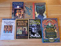 All seven paperback books laid out together