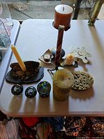 Full group of candle holders and candles on table
