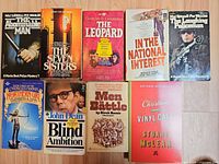 All nine paperback books laid out face up
