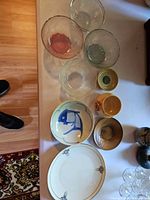 Group shot of all nine porcelain, ceramic and glass pieces on table