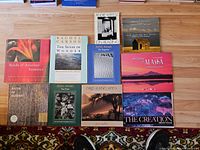 All eleven oversized hardcover books laid out together