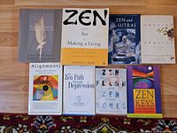 Seven of the paperback books laid out showing front covers and titles