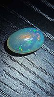 Top view of oval jelly opal showing play-of-color