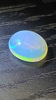 Top view of oval Ethiopian opal showing play of colour