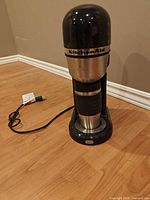 Front view of KitchenAid single-serve coffee maker with power cord