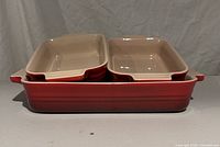 All three dishes stacked showing size relationship and exterior red glaze
