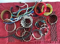 Assortment of bracelets laid out showing variety of styles, materials and colours