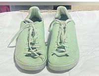 Front view of the mint Adidas sneakers showing toe boxes, laces, and knit pattern