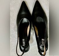 Top view of both shoes showing pointed toes, brand insole, slingback straps