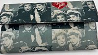 Front of clutch showing photo collage pattern and red heart logo