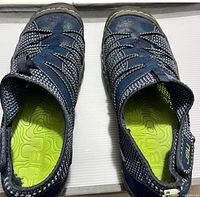 Top view of both shoes showing mesh pattern, lime green insoles, toe cap wear