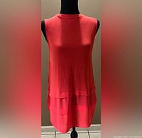 Front view of coral sleeveless shift dress on mannequin