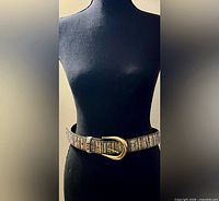 Full view of belt on mannequin showing buckle and overall appearance