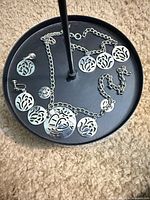 Full set laid out showing necklace with multiple disc charms and both earrings