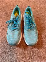 Pair of teal Skechers running shoes viewed from top showing laces and uppers