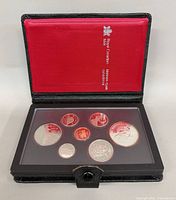 Closed display case opened showing coins in plastic holder