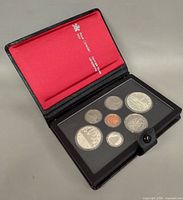 Open case showing coins in holder