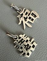 Front view of both silver pendants