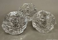 Three Kosta Boda snowball votive holders grouped