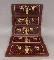 Front view of all five panels laid flat showing gilt carvings and lattice