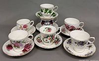 Group shot showing all seven teacup and saucer sets