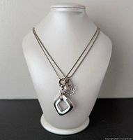 Necklace on display bust showing dual strands and pendants
