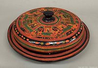 Closed lacquered box showing side profile and painted design