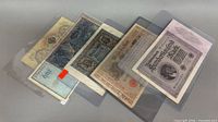 Five banknotes overlapped in individual sleeves